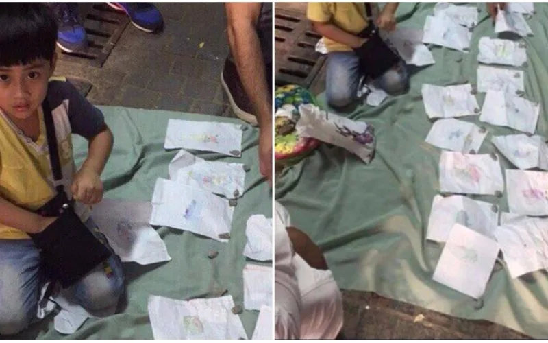 innocent Muslim child is selling his simple drawings to help his family