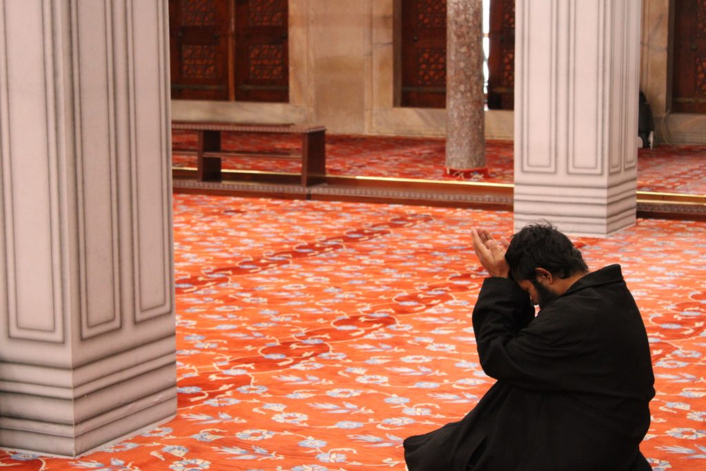 man praying in turkish mosque