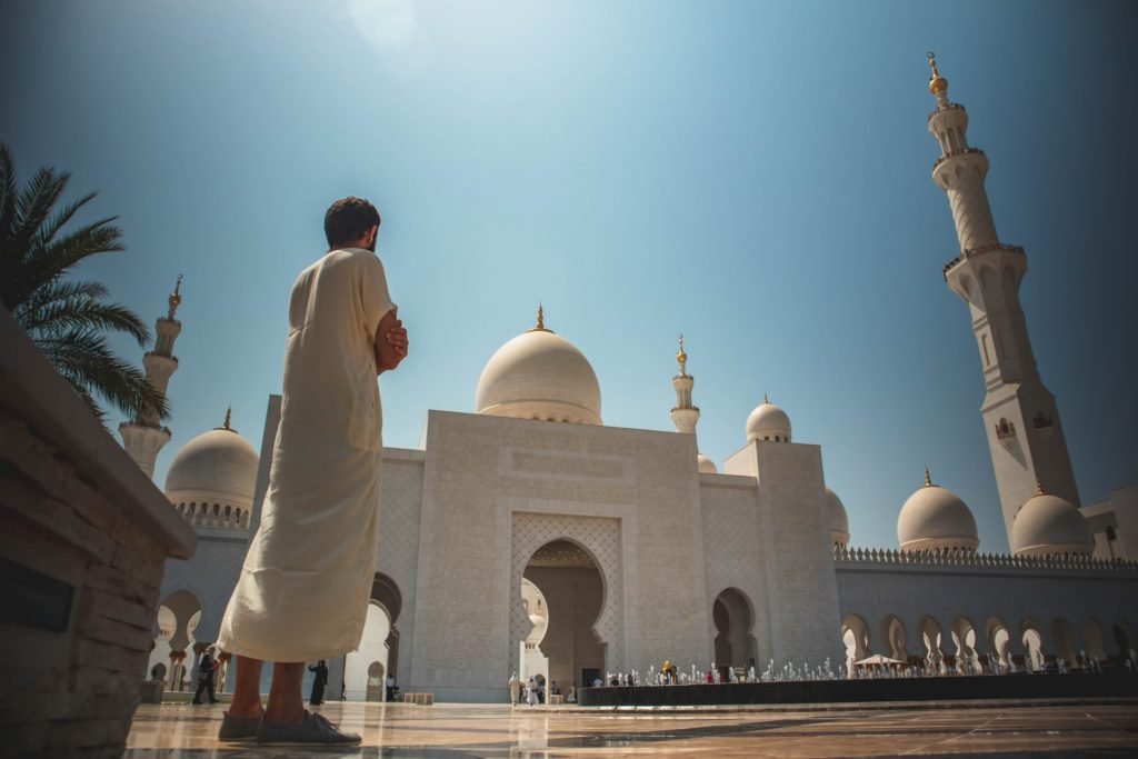 man standing dubai mosque