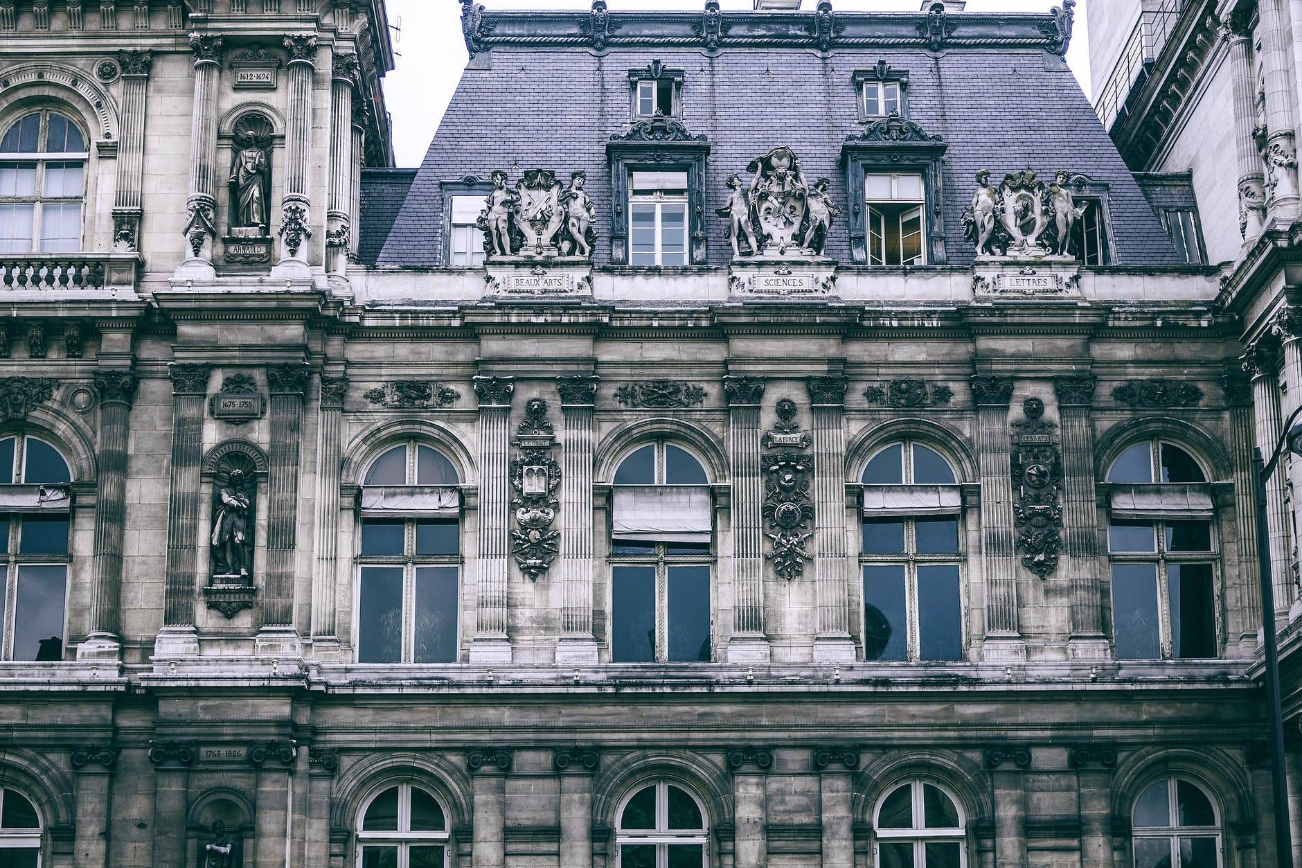 facade of typical classic french building with sculptures