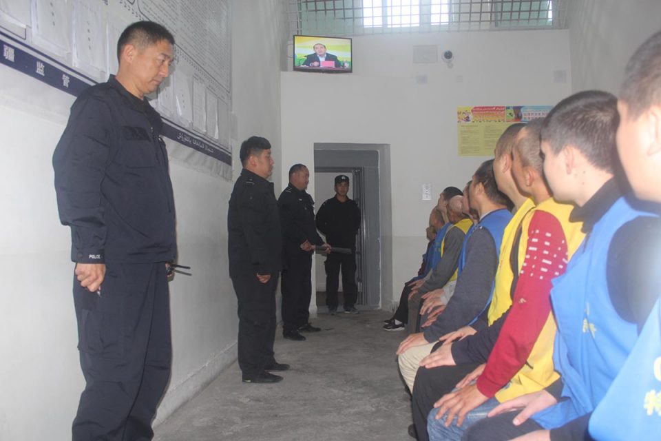 Detainees under guard watching speech 960x640 1