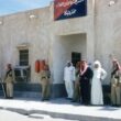 Saudi men outside police station