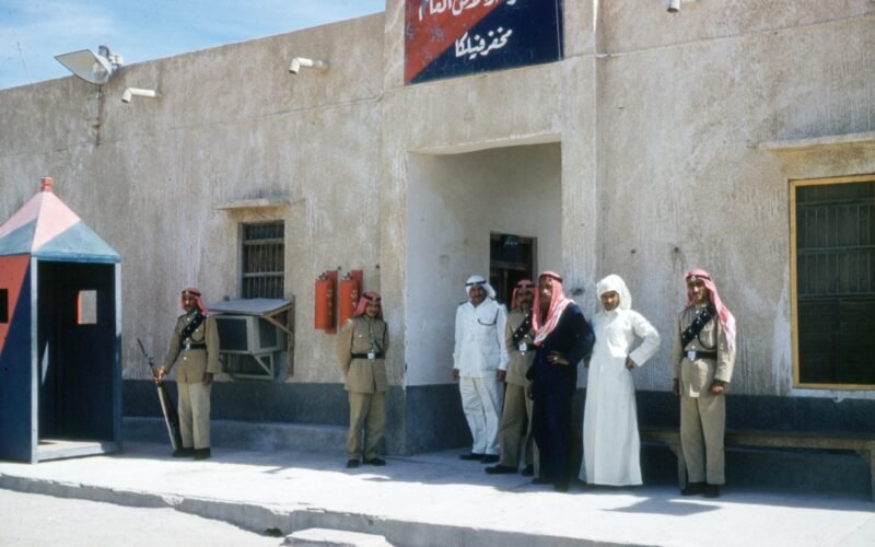 Saudi men outside police station