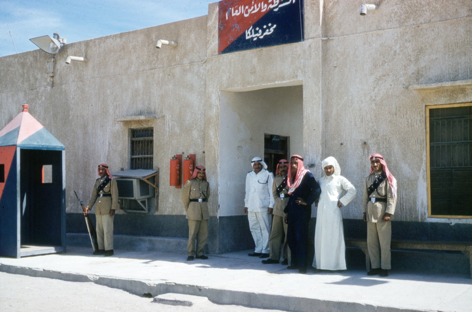Saudi men outside police station