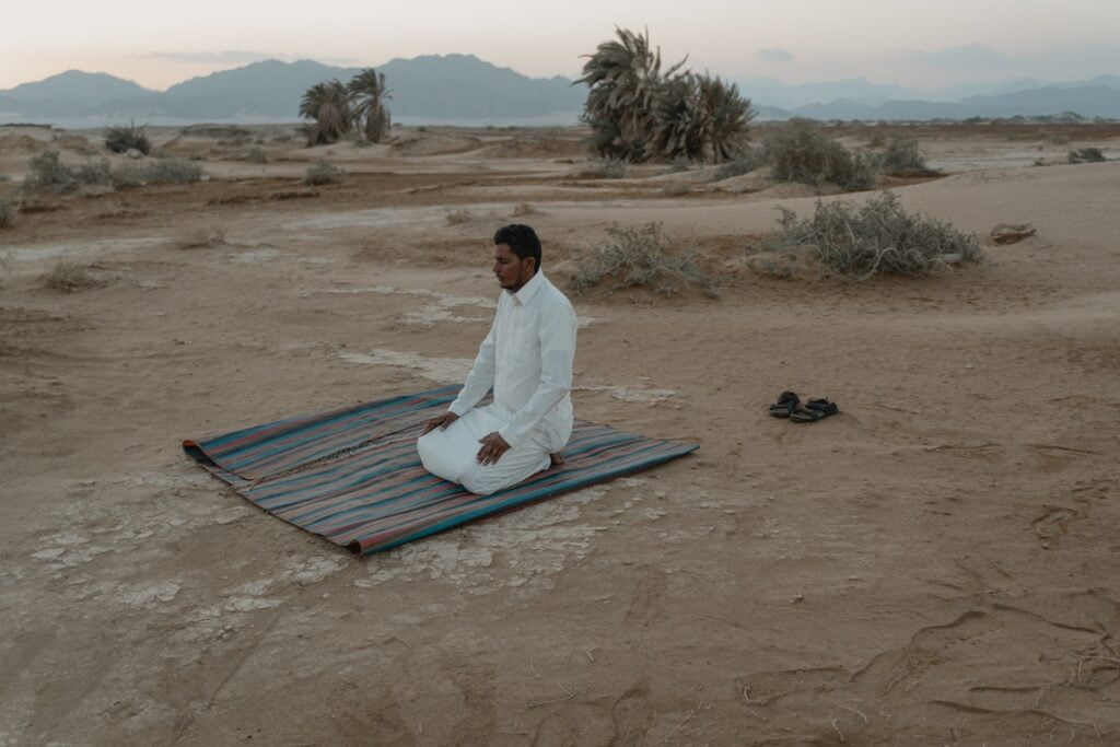 muslim man praying desert