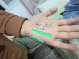 Gaza children writing name on hands