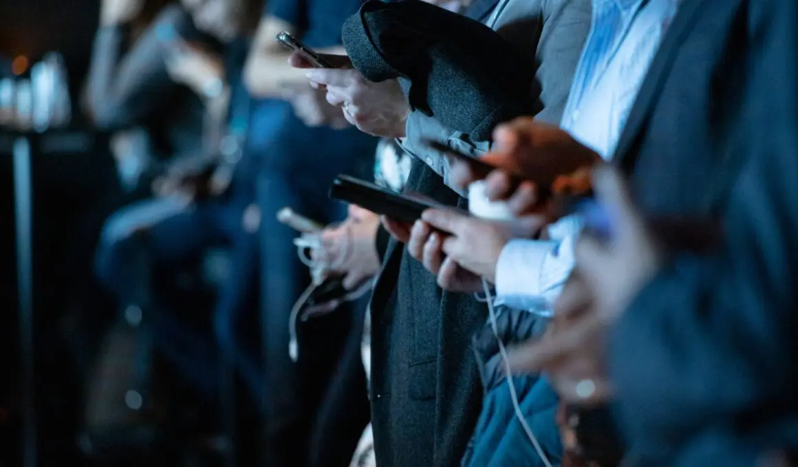 group of people using smartphones to check messages