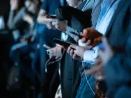 group of people using smartphones to check messages