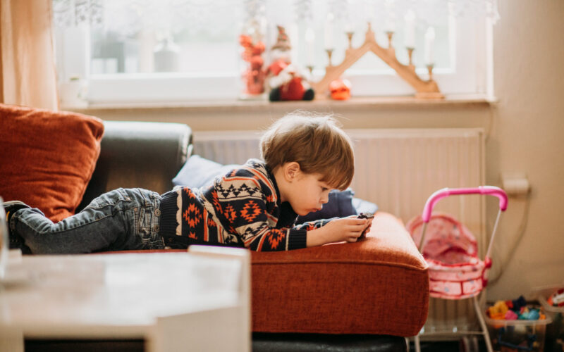 Little boy playing games on smartphone