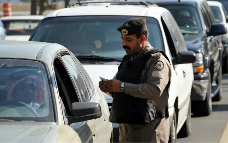 Saudi policeman checking permits