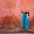 lady in hijab going inside the door middle east