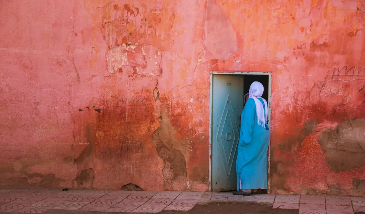 lady in hijab going inside the door middle east