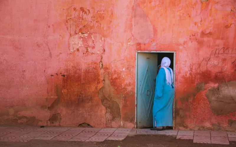 lady in hijab going inside the door middle east