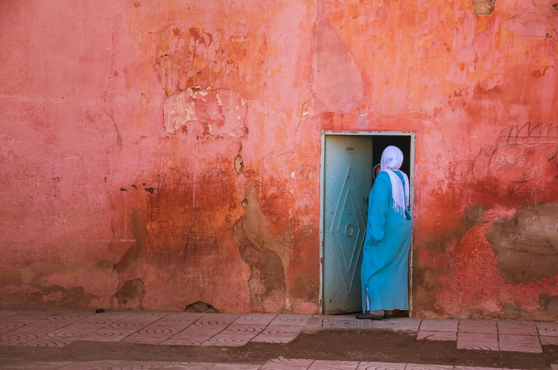 lady in hijab going inside the door middle east