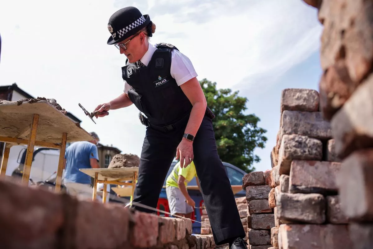 Merseyside Police Chief Constable Serena Kennedy helping rebuilding the wall of the mosque. Photo PA