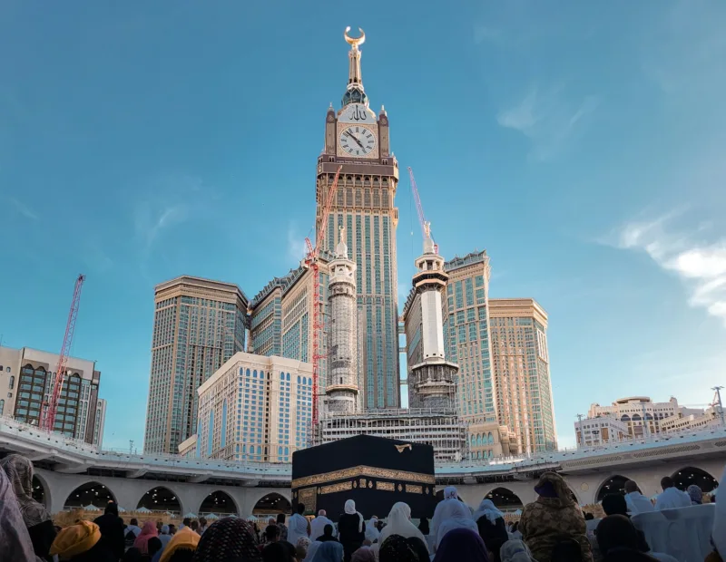 a group of people standing in front of a tall building