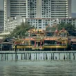 a pier with some buildings in the background IN PENANG