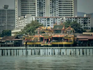 a pier with some buildings in the background IN PENANG