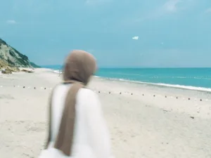 woman in hijab at the beach