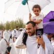 hajj pilgrims 2024 with kid on shoulders