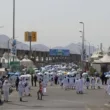 pilgrims going towards mina tents