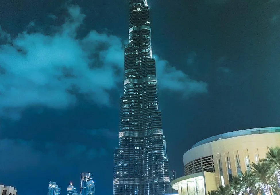 people standing near high rise building during night time