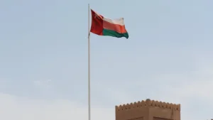 omani flag flying over historic fort gate