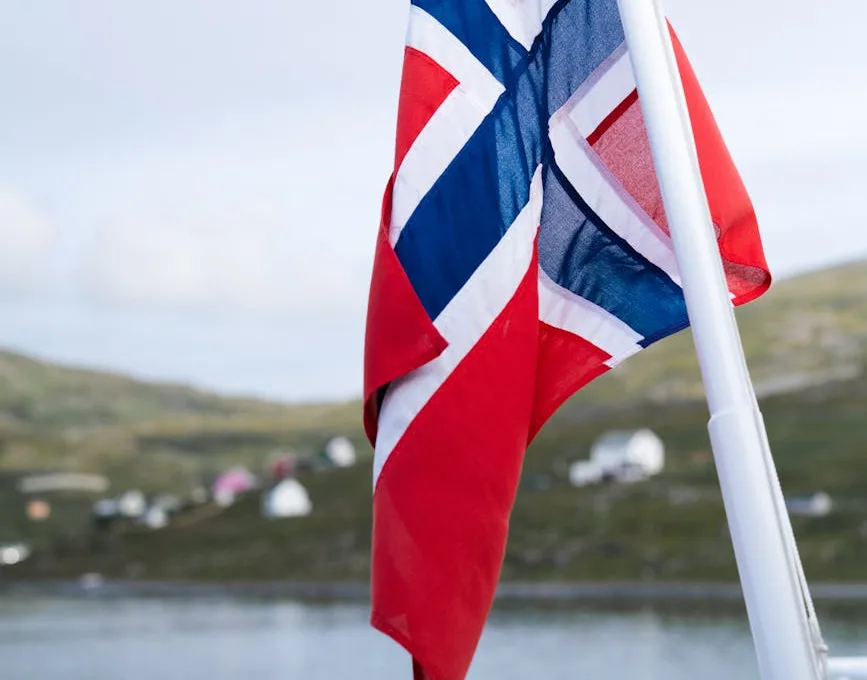 norwegian flag with mountains and lake in the background