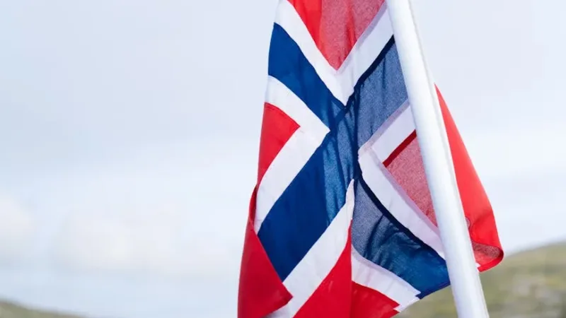 norwegian flag with mountains and lake in the background