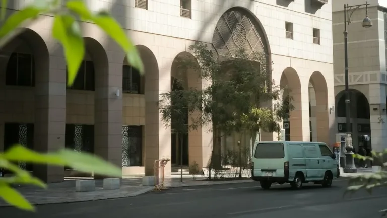 van on street with building near