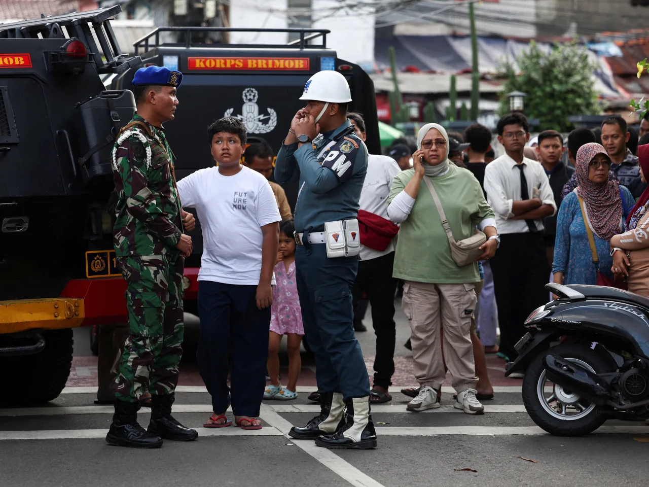 Troops guard site as residents gather after Jakarta school complex explosion
