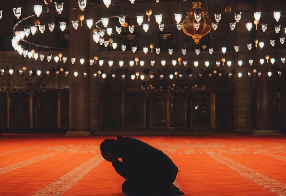 man praying in mosque