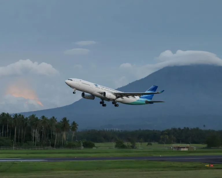 Garuda Indonesia airliner in flight over runway