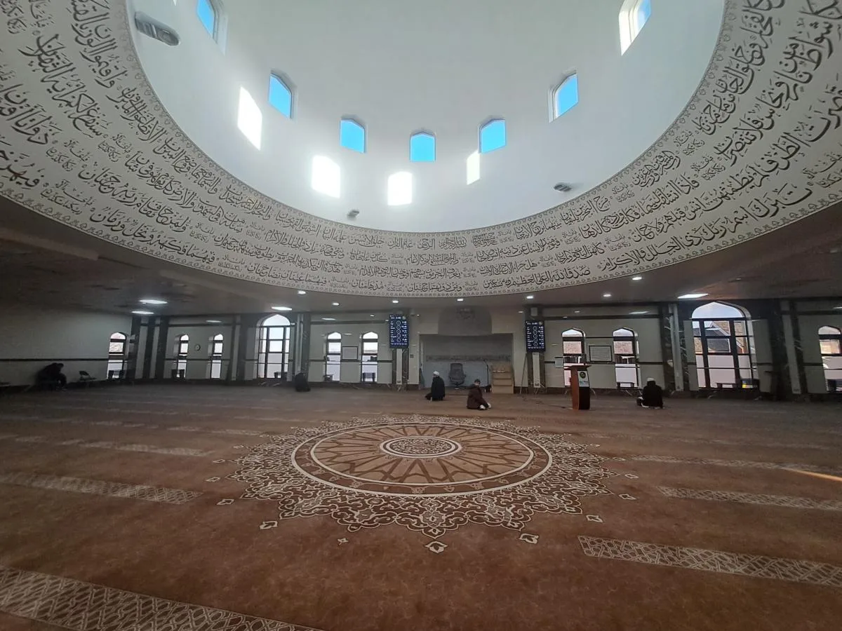 The upstairs prayer room, featuring a grand central dome, exudes a sense of tranquility and reverence.