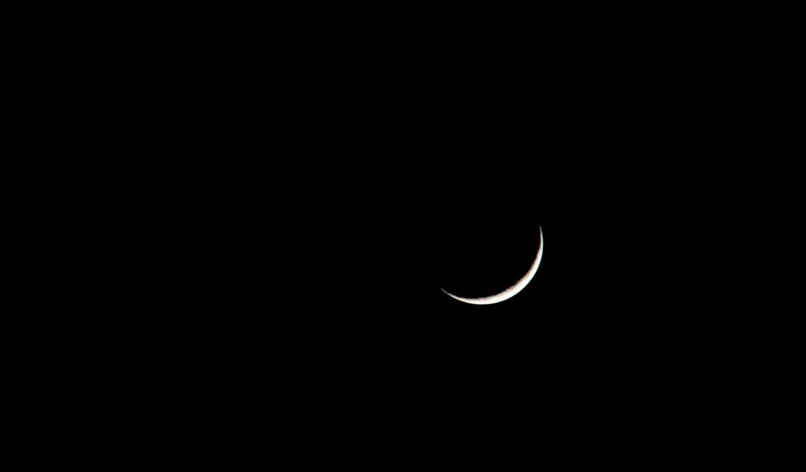crescent on black sky