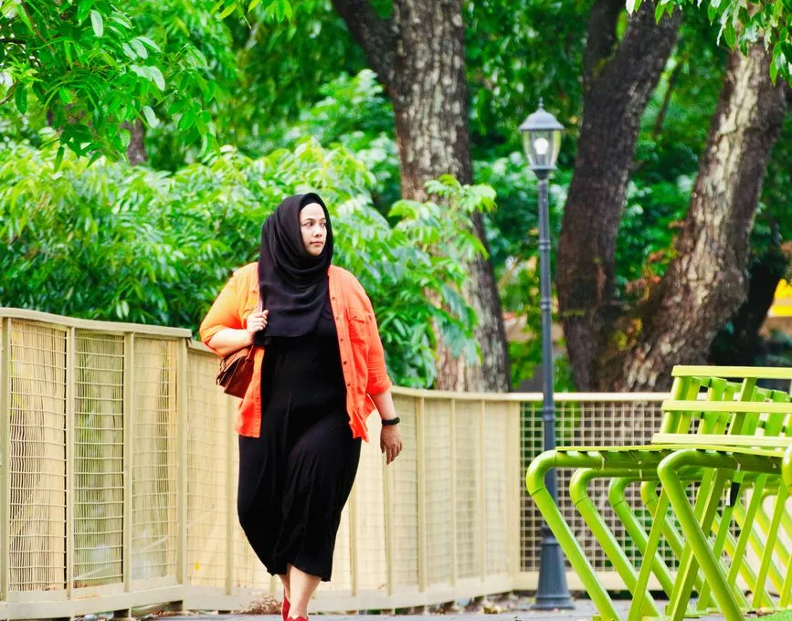woman walking in park on a sunny day