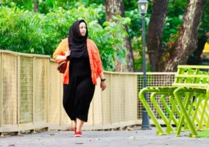 woman walking in park on a sunny day
